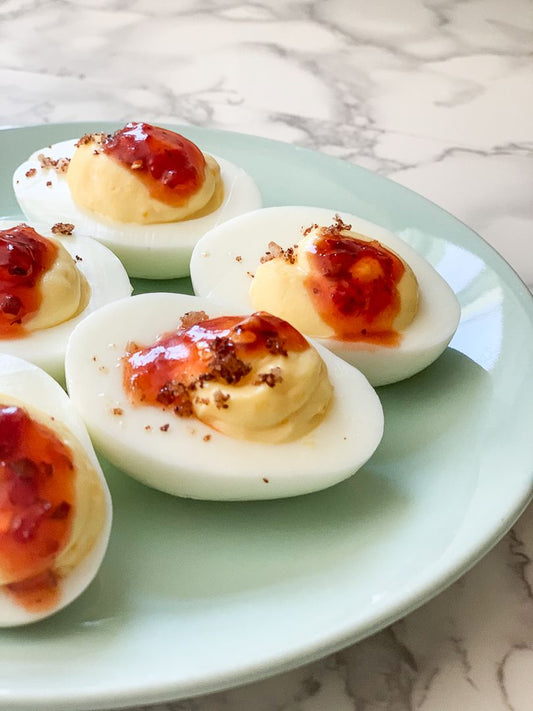 Pepper Jelly Deviled Eggs with Sumac Paprika Salt